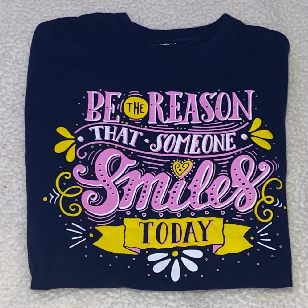 Shirt colors pink and yellow and a really deep blue with quote